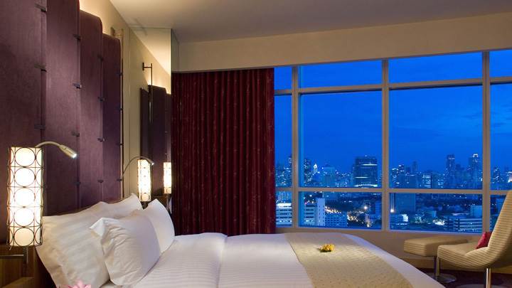White Bed And Dark Brown Curtain In Bedroom